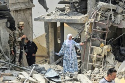 Une femme dans les décombres d'un bâtiment touché par une frappe aérienne israélienne sur Tyr, le 28 mai 2026 dans le sud du Liban - © AFP - KAWNAT HAJU