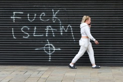 Un graffiti anti-islamique sur un rideau métallique, au lendemain de manifestations qui ont dégénéré en violences à Belfast, en Irlande du Nord, le 10 juin 2026 - © AFP - Paul Faith